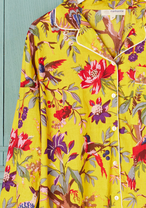 Floral and bird patterned nightshirt on a light blue background