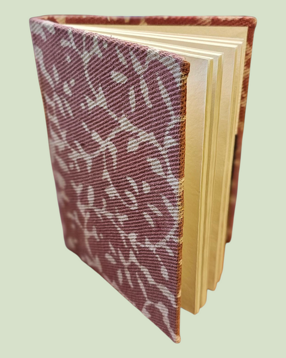 Book with a patterned cover on a light green background