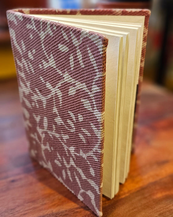 Book with a patterned cover on a wooden surface