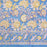 Aasmani hand-block-printed cotton tablecloth with pink and yellow botanicals on a dusty blue background