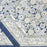 A folded back blue and white tablecloth with a floral block printed design