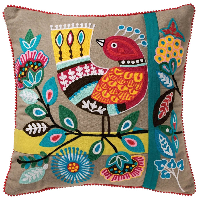 Decorative pillow with colorful bird and floral pattern on a beige background