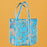 Blue floral tote bag on a mustard yellow background