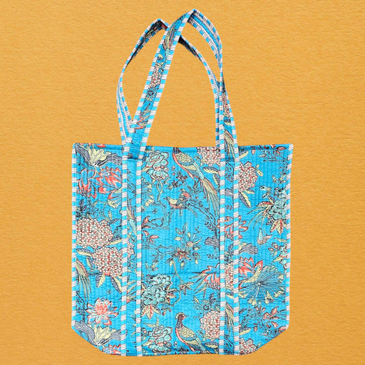 Blue floral tote bag on a mustard yellow background