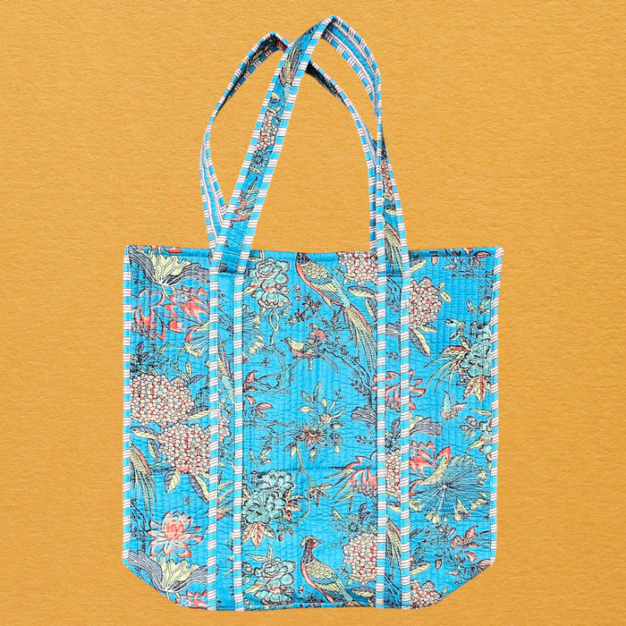 Blue floral tote bag on a mustard yellow background