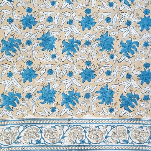 Patterned fabric with blue and white floral design on a beige background
