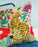 Decorative pillow with a tiger and floral design on a blue background