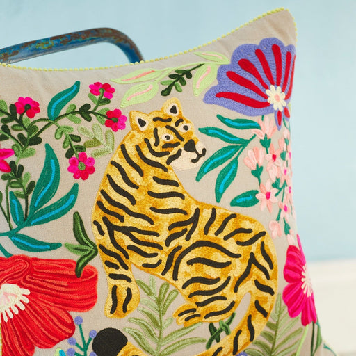 Decorative pillow with a tiger and floral design on a blue background