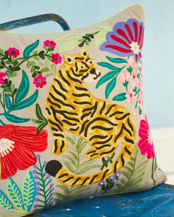 Decorative pillow with a tiger and floral design on a blue background