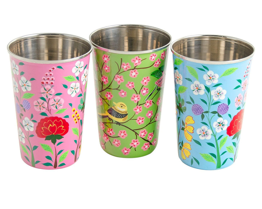 Three stainless steel tumblers with floral and nature-themed designs