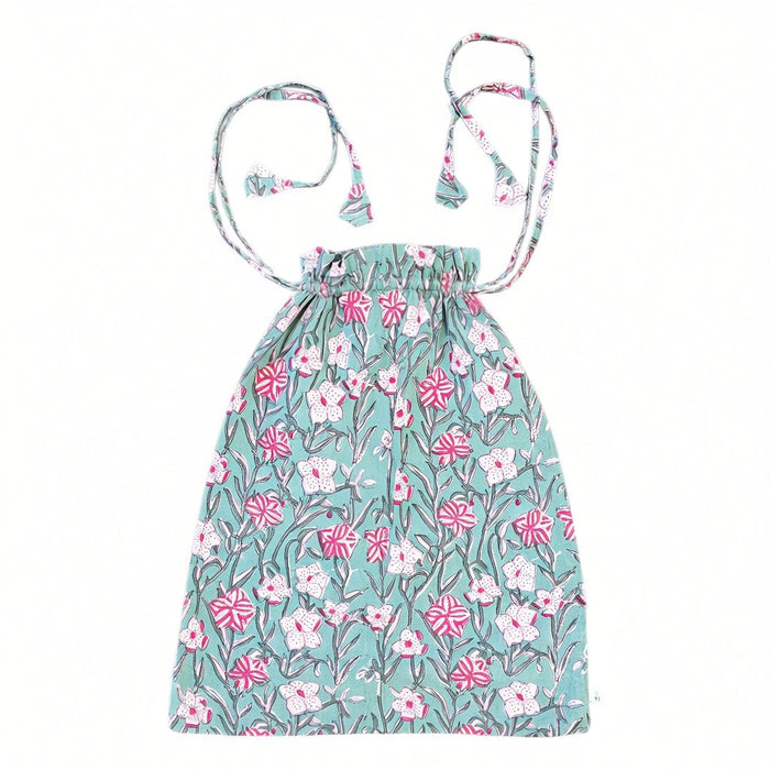 Constance Block-Printed Cotton Short Pyjama Set Drawer string Bag with a pink and white floral design on a green background, set against a plain white background.