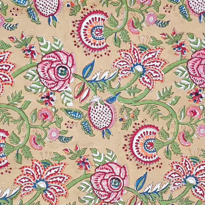 Macro detail of hand-block printing on cotton, highlighting the sage green vines, dusty rose flowers, and cross-hatched pomegranate motifs using ecofriendly dyes.