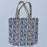 Tote bag with blue floral pattern on a light blue background