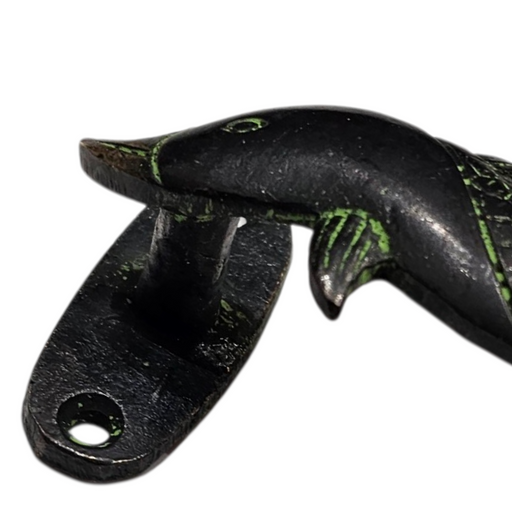 Close up image of the head of a Dolphin Design Green Patina Brass Handle on a white background