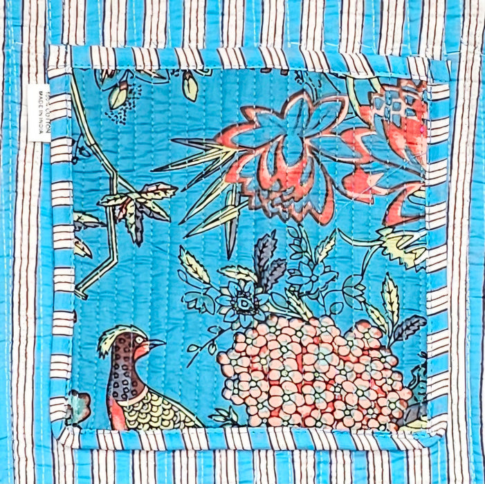 Fabric slip pocket with a floral and bird design on a blue background