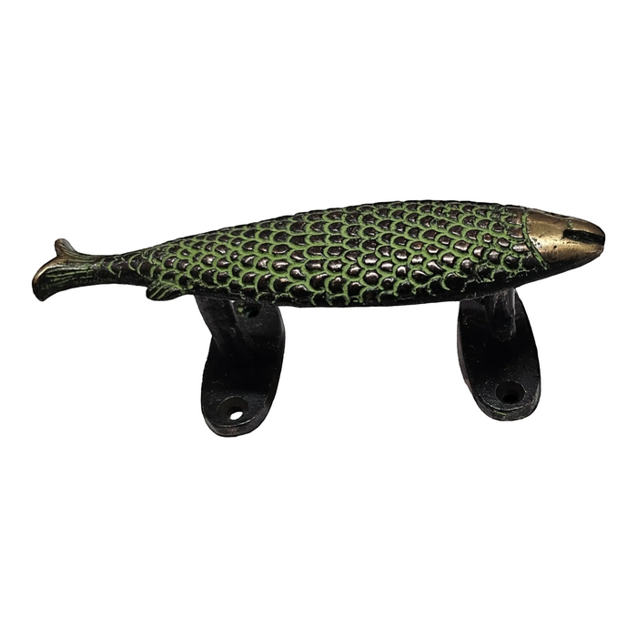 A brass handle in the shape of a fish with a green patina on a white background