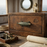 Vintage wooden chest with brass fish handle and ship emblem, surrounded by nautical items including a lantern and a map.