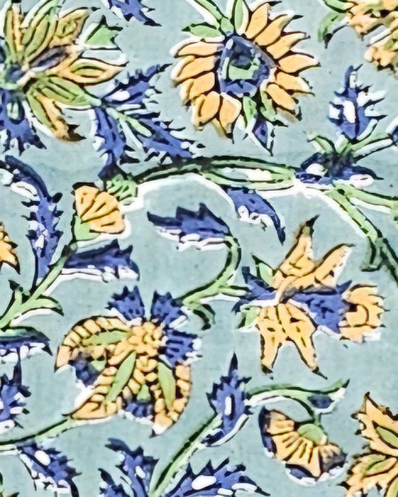 Close up of a Green Block Print Tablecloth with a Yellow and Blue Floral Motil