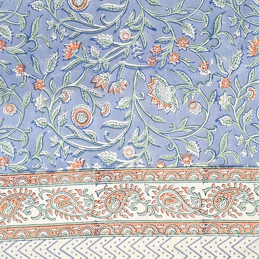 Blue block printed cotton tablecloth with a green and orange floral design.