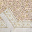Hand Block Printed Cotton Tablecloth with scrolling vines and Tulip design in a soft brown colour palette.  Folded back to show the border design.