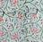 A square block-printed tablecloth featuring a floral pattern in shades of pink and green, on a pale turquoise background.