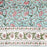 Block printed tablecloth with a pink and green floral design on a pale turquoise background and a white floral border