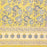 A hand block printed tablecloth with a blue and grey foral design on a mustard yellow background.