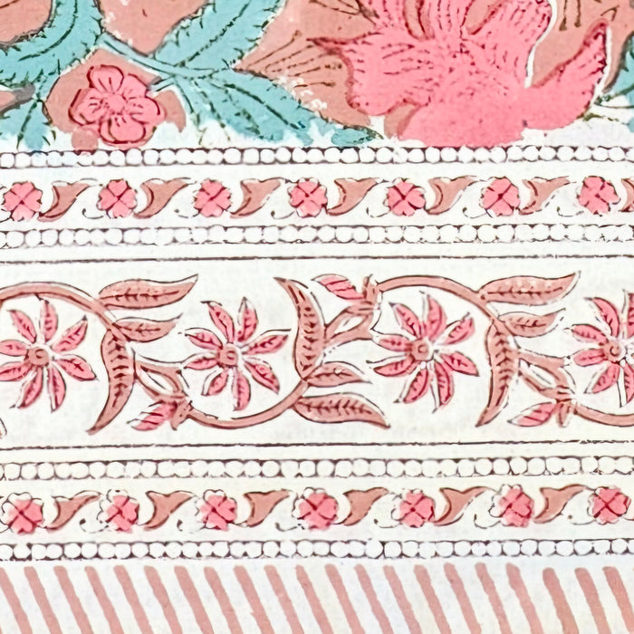 A close up picture of the border of a  block printed cotton tablecloth.