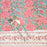 Hand block printed cotton tablecloth with a pink lily design and green leaves on an earthy pink background.  A knife and fork are shown to indicate the size of the pattern