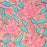A close up picture of a block printed cotton tablecloth with a pink lily design and green leaves on an earthy pink background.  