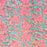 A block printed cotton tablecloth with a pink lily design and green leaves on an earthy pink background.