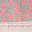 Hand block printed cotton tablecloth with a pink lily design and green leaves on an earthy pink background.  The border of the tablecloth can be seen.