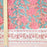 Hand block printed cotton tablecloth with a pink lily design and green leaves on an earthy pink background.  A meter ruler gives the scale of the pattern.