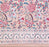 Decorative fabric with red, blue, and white floral patterns on a beige background.