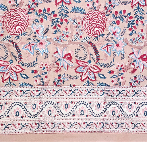 Decorative fabric with red, blue, and white floral patterns on a beige background.