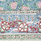 Close-up of intricate floral and geometric pattern with red, white, and green colors.