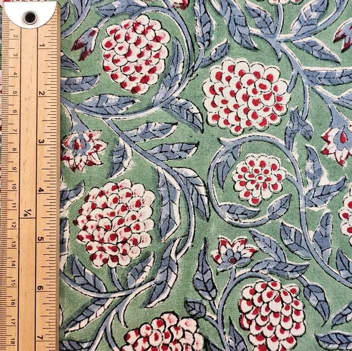 Floral patterned fabric with a ruler for scale on a green background
