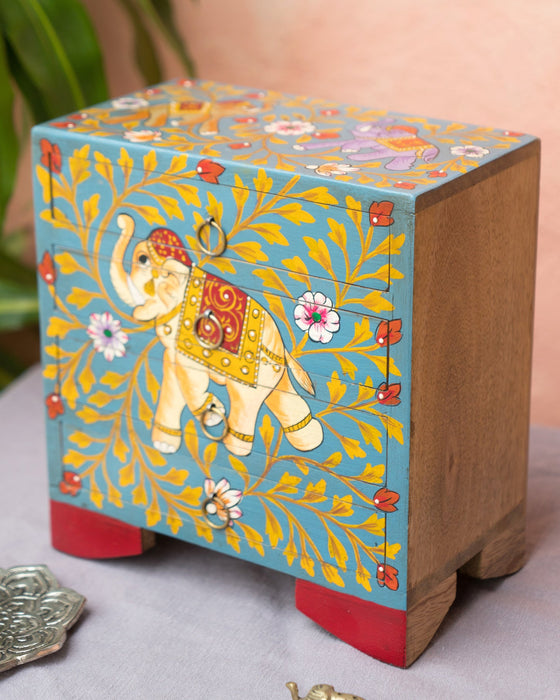 Decorative wooden box with elephant design on a light background