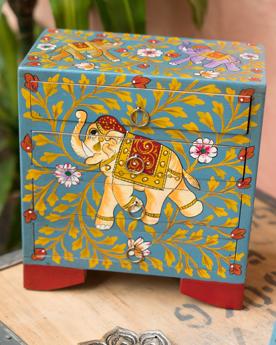 Decorative box with an elephant design on a wooden surface