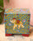 Decorative box with elephant design on a wooden surface
