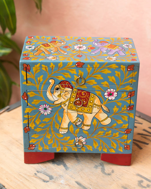 Decorative box with elephant design on a wooden surface