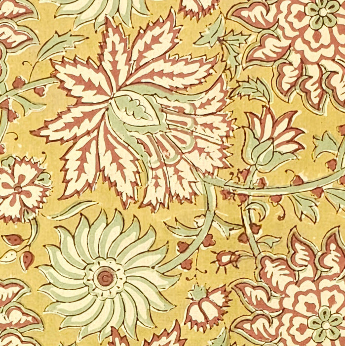 Detailed image of Golden turmeric hand-block printed cotton tablecloth with terracotta floral vines and sage green accents.