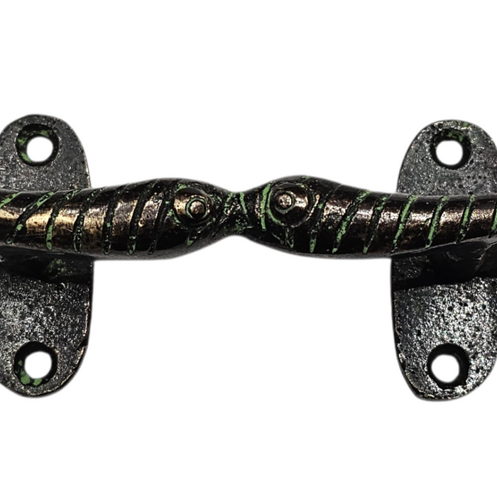 Close up image of a Kissing Fish Design Green Patina Brass Handle on a white background