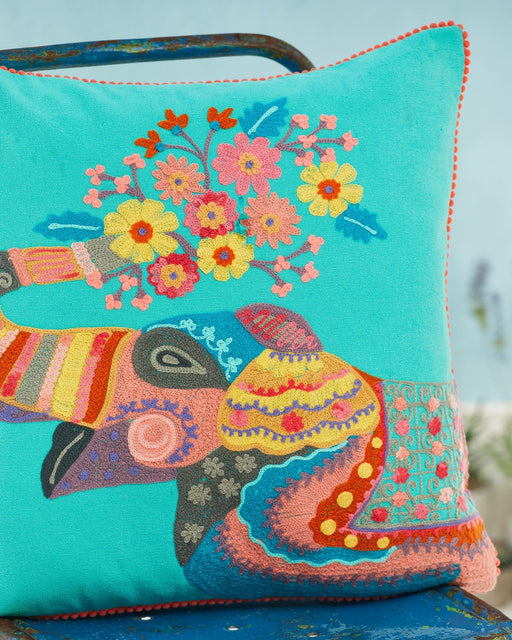 Close-up picture of a colourful embroidered pillow with an elephant design