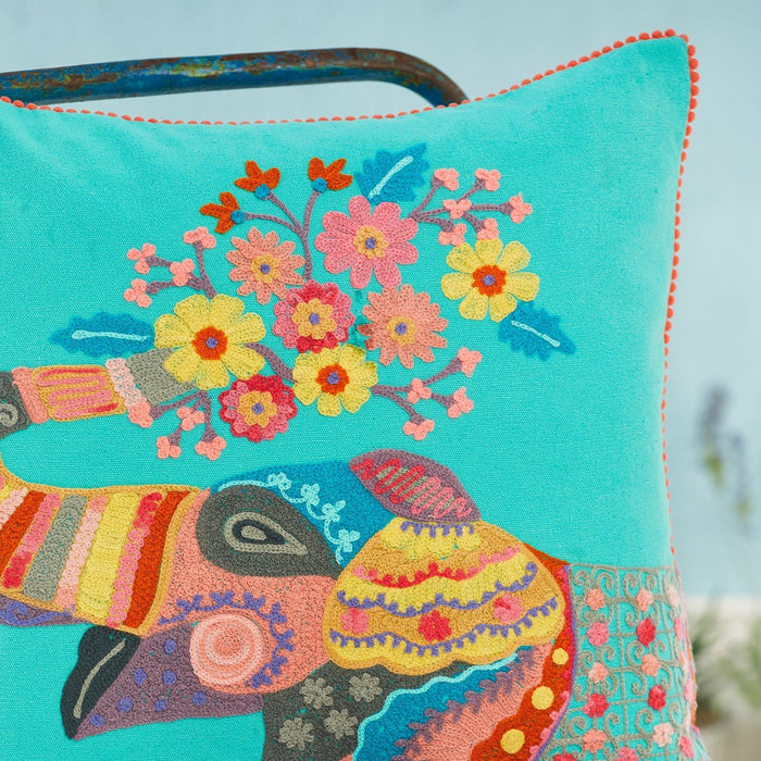 Close-up picture of a colourful embroidered pillow with an elephant design