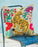 Decorative pillow with a tiger design on a chair against a light blue background