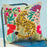 Decorative pillow with a tiger design on a chair against a light blue background