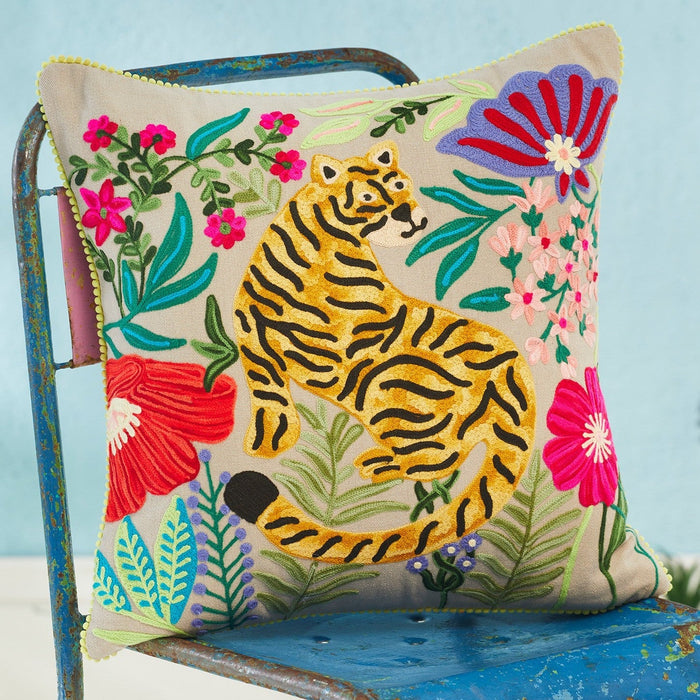 Decorative pillow with a tiger design on a chair against a light blue background