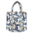 Product view of a quilted cotton tote bag featuring a white and ochre crane screen print on a midnight blue background. The image clearly shows the sturdy reinforced shoulder straps and the textured, linear quilting against a crisp white backdrop.