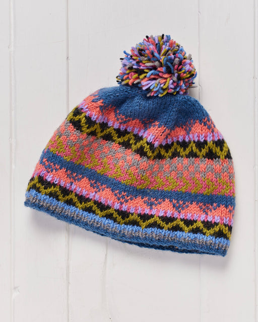 A hand knitted and fleece lined Namche Pompom Beanie Hat.